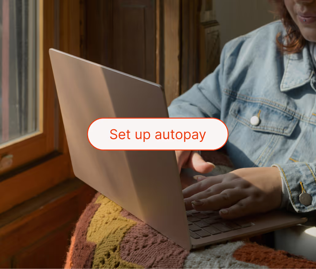"Set up automatic payments" message in front, and a person typing in the back