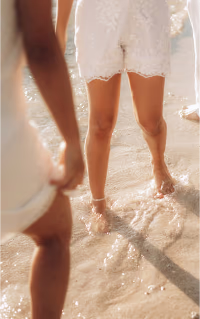 A group of people dressed in white at a beach